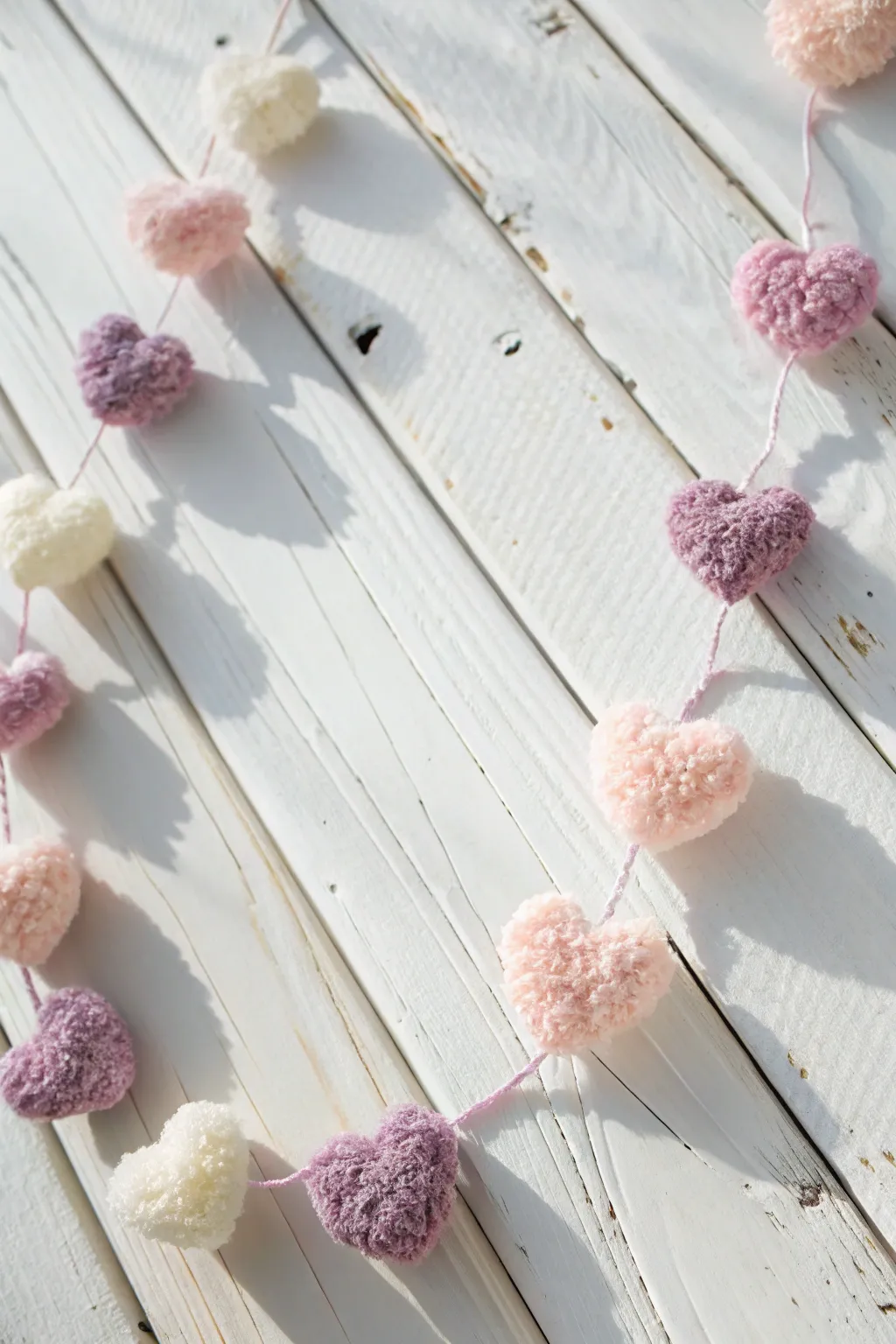 Add a whimsical touch to your decor with a heart-shaped pom-pom garland, perfect for crafting and gifting this Valentine's Day.